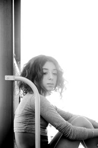 Portrait of girl sitting at doorway