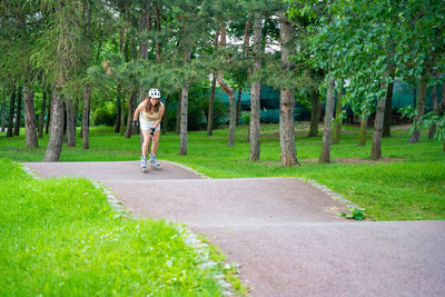 Rear view of man riding bicycle on field