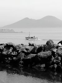 People on shore against sky