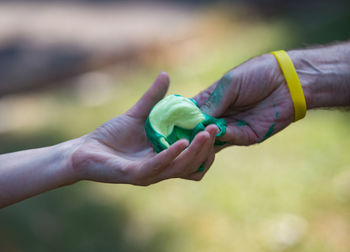 Close-up of man holding leaf