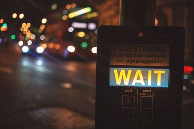 Close-up of information sign at night