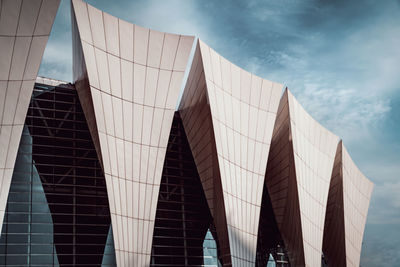 Modern building against cloudy sky