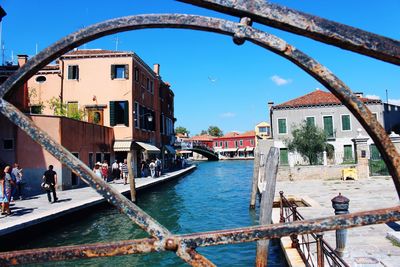 Bridge over canal against buildings in city