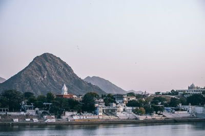 Scenic view of sea and mountains against clear sky