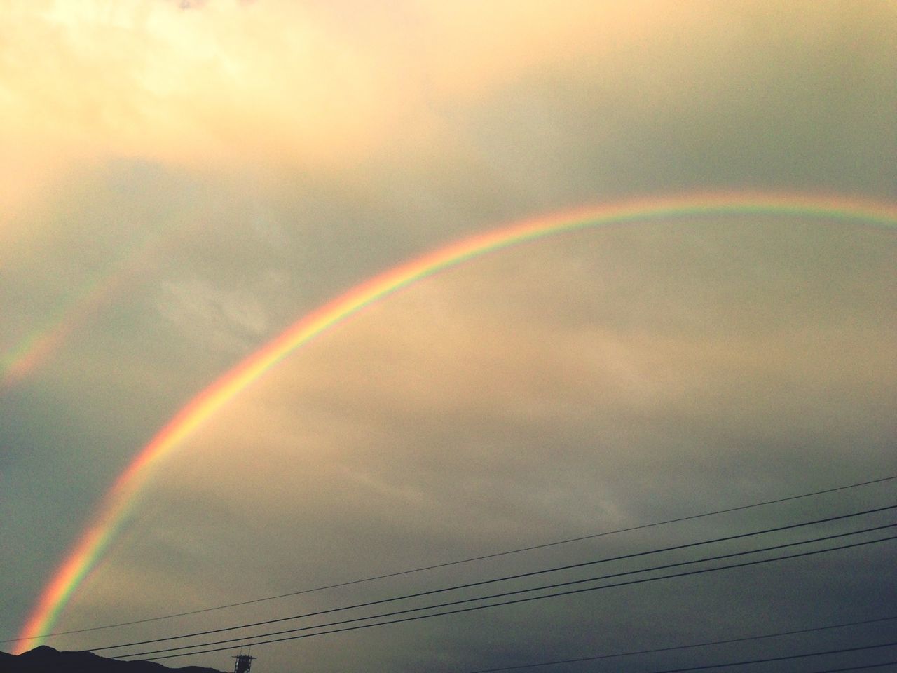 rainbow, sky, multi colored, low angle view, cloud - sky, beauty in nature, sunset, scenics, nature, tranquility, cloudy, weather, tranquil scene, outdoors, no people, idyllic, cloud, orange color, dramatic sky, colorful