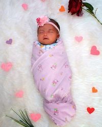 Portrait of cute baby sleeping in bed