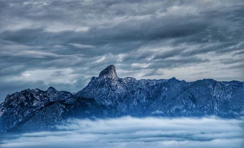 Scenic view of mountains against cloudy sky