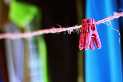 Low angle view of clothespins hanging on rope