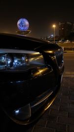 View of illuminated cars on street at night