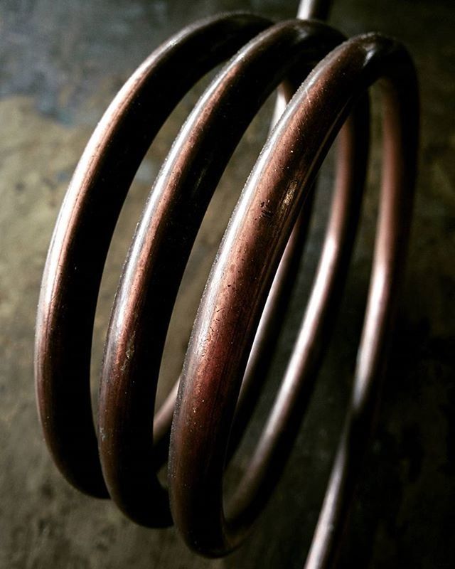 close-up, metal, still life, metallic, focus on foreground, selective focus, single object, pattern, spiral, no people, textured, man made object, indoors, table, shape, day, simplicity, detail, two objects