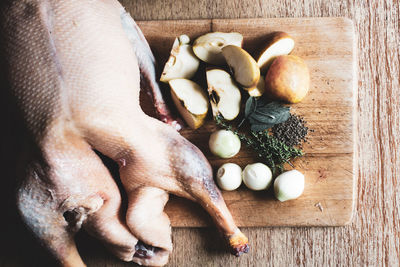 Cropped hand of man holding food on table