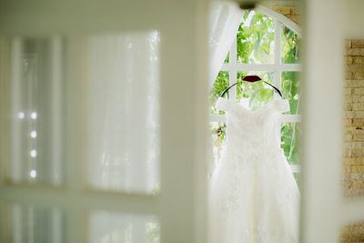 Close-up of white dress on hardwood floor