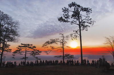 Silhouette people against sky during sunset