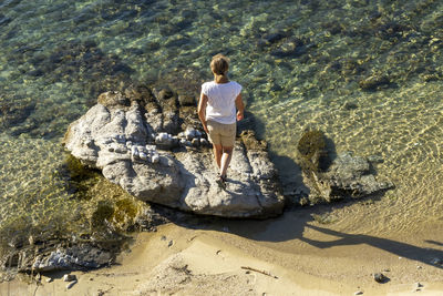 Rear view of man standing at beach