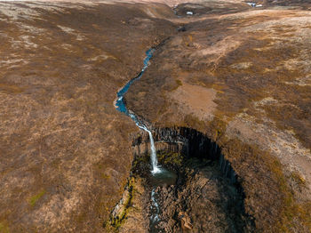Aerial view of the svartifoss waterfall surrounded by basalt columns