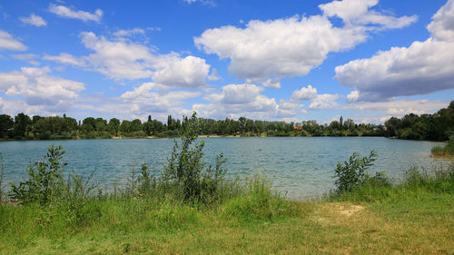 Dramatic cloudy sky over the urban lake in the middle of 22nd district of vienna in july.