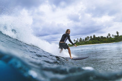 Man enjoying surfing in sea