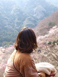 Rear view of woman against mountain range