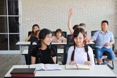 Group of friends sitting on table