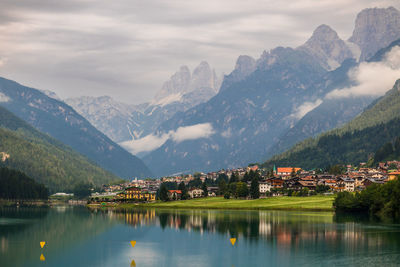 Scenic view of lake by mountains against sky