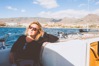 Woman traveling in boat on sea