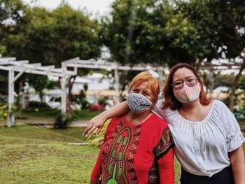 Full length of woman standing outdoors during pandemic