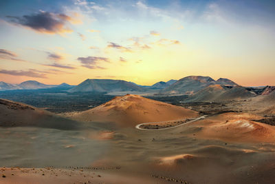 Scenic view of desert against sky during sunset