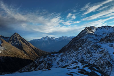 Scenic view of mountains against cloudy sky