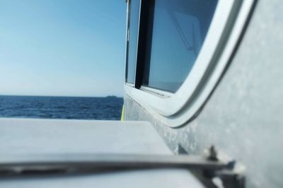 Close-up of sailboat in sea against sky