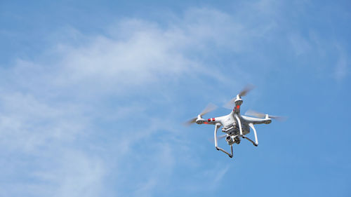 Low angle view of airplane flying against sky