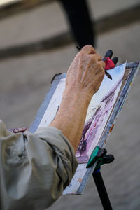 Close-up of hand painting on paper