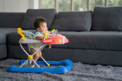 Boy sitting on sofa at home