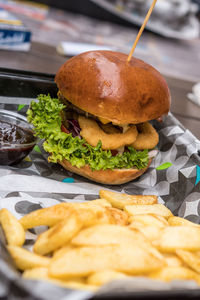 Close-up of burger on table with fries