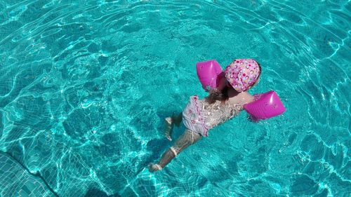 High angle view of girl swimming in pool