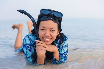 Portrait of smiling boy with sea in background