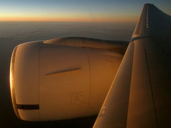 Cropped image of airplane at sunset