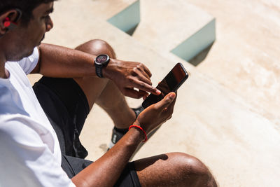 Midsection of man using mobile phone