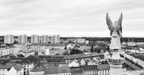 Angel statue overlooking cityscape