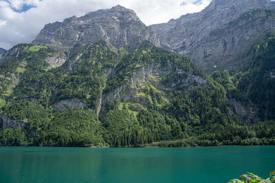 Scenic view of lake and mountains against sky