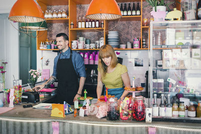 Man and woman working at cafe counter