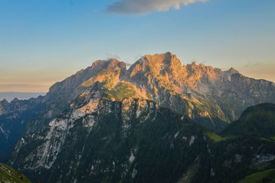 Scenic view of snowcapped mountains against sky during sunset