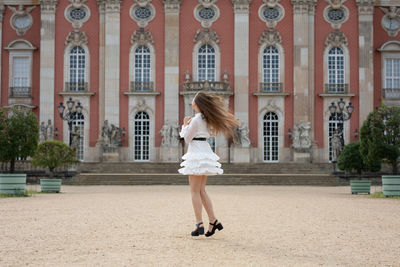 Woman standing against building