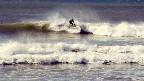 People surfing in sea