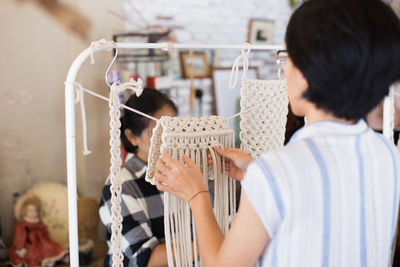 Rear view of woman making decoration at store