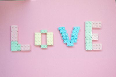 High angle view of love text made from plastic blocks on table