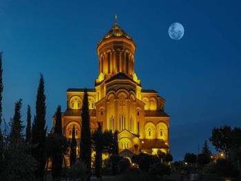 Low angle view of illuminated building against sky at night