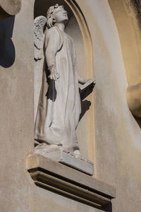 Low angle view of statue against building