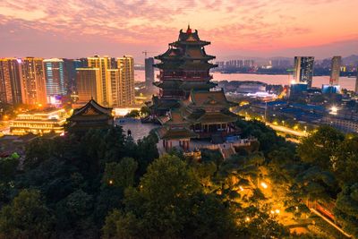 High angle view of illuminated buildings at sunset