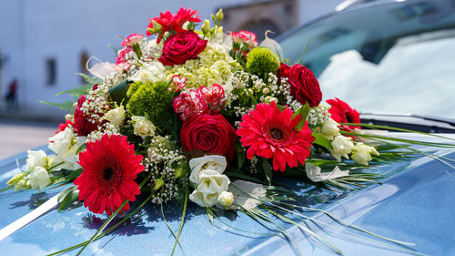 Wedding flowers bouquet close-up tied on the wedding car