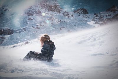 Woman standing on snow covered landscape during winter